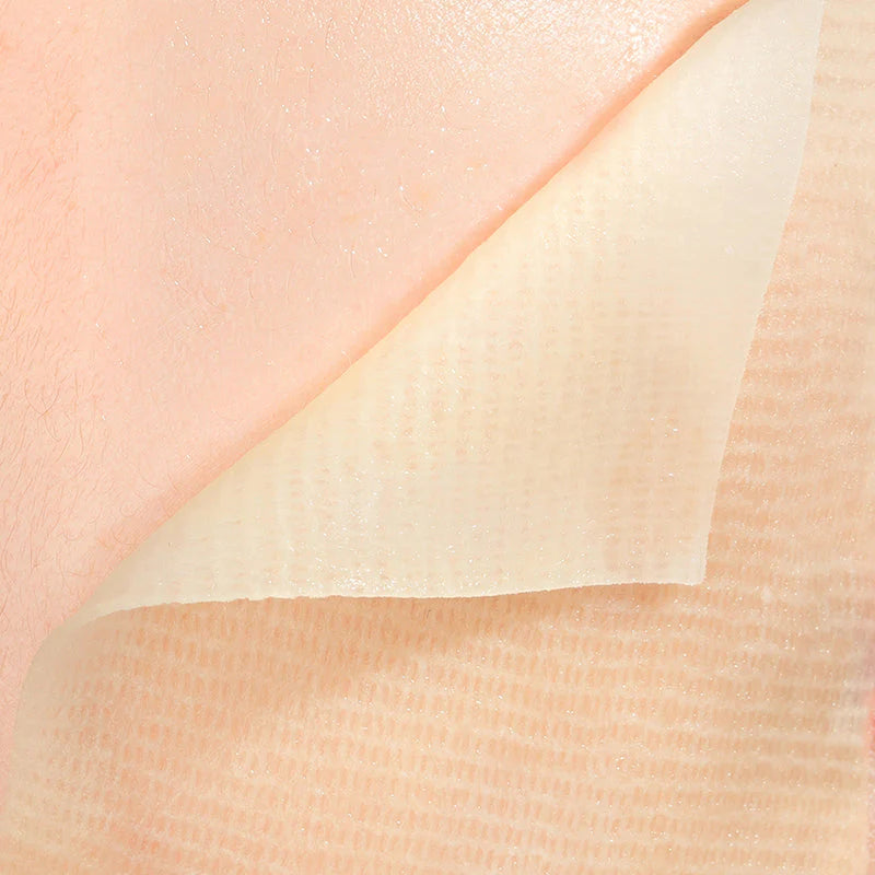Close-up of a skin-like texture with a gradient from pink to beige.