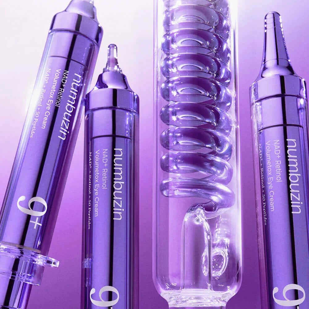 Set of Numbuzin eye cream bottles on a purple background